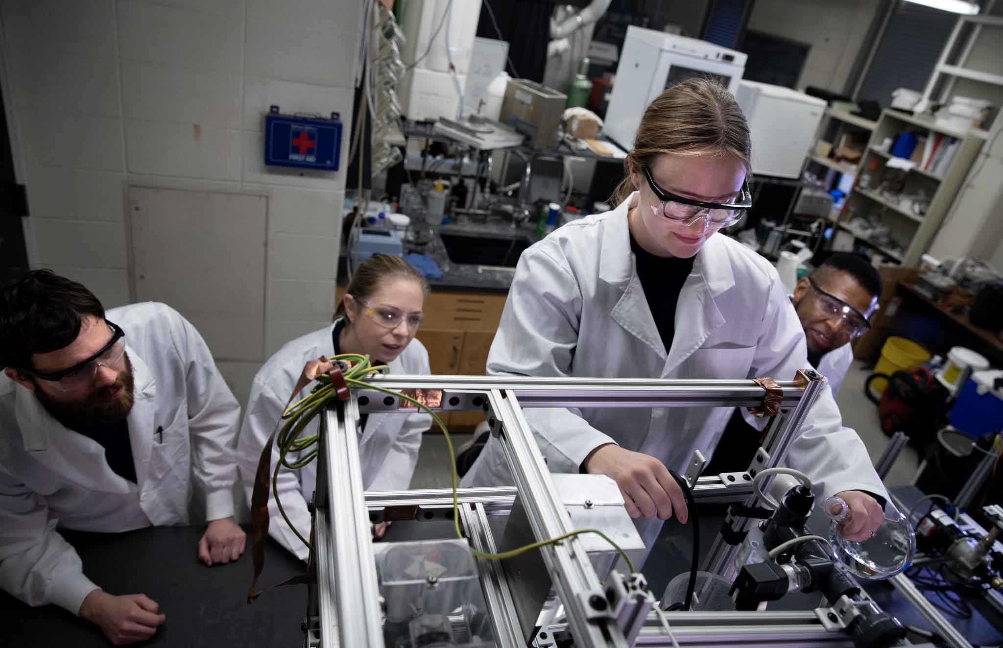 four people working in a lab