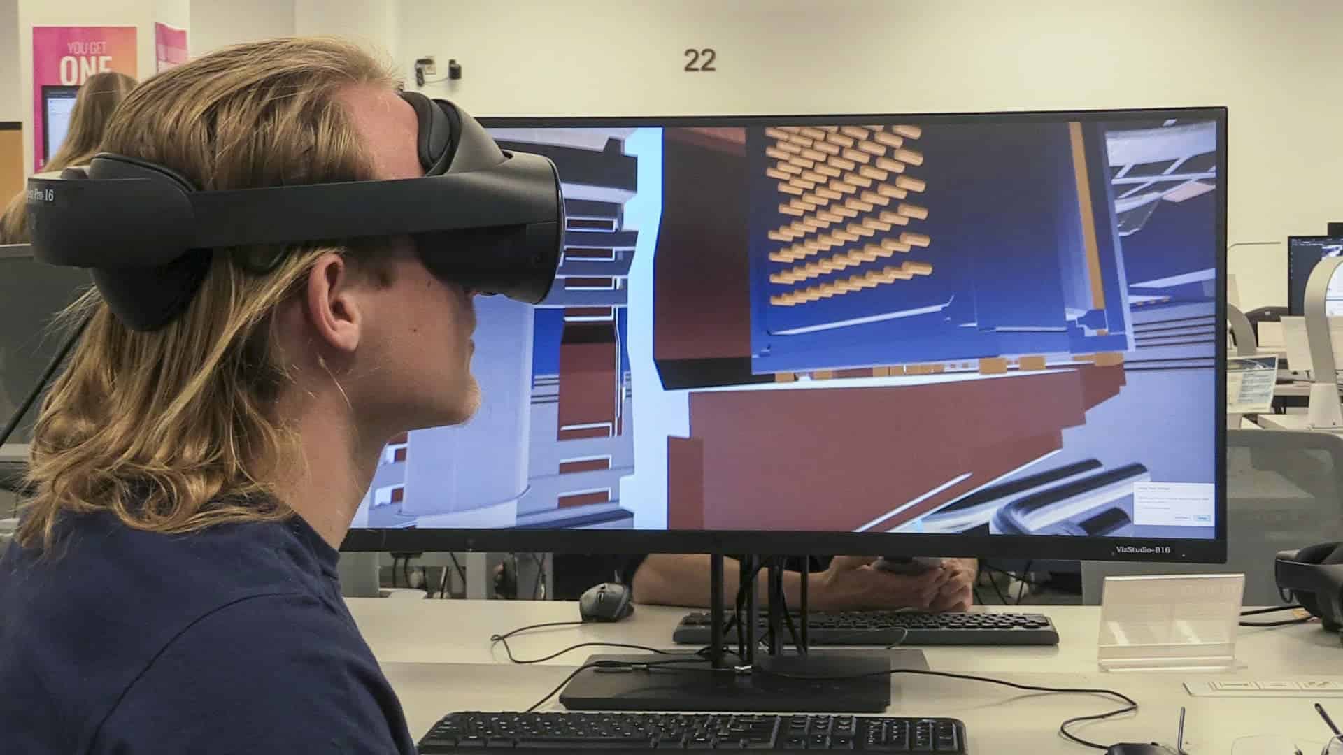 man using VR technology in front of a computer screen