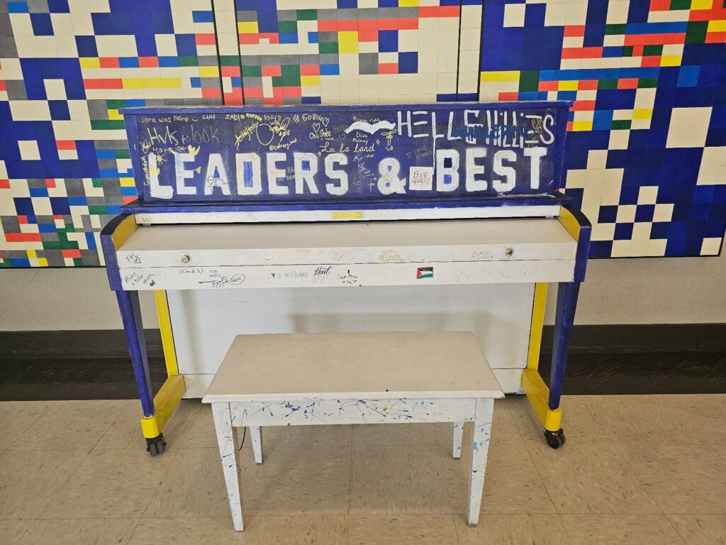 a piano painted to say "leaders and best"