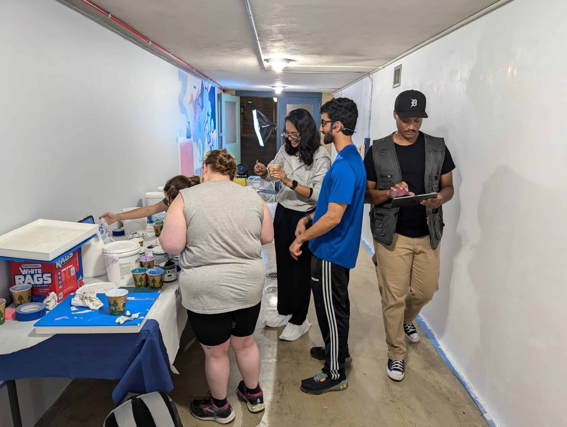 students play with paint in a corridor