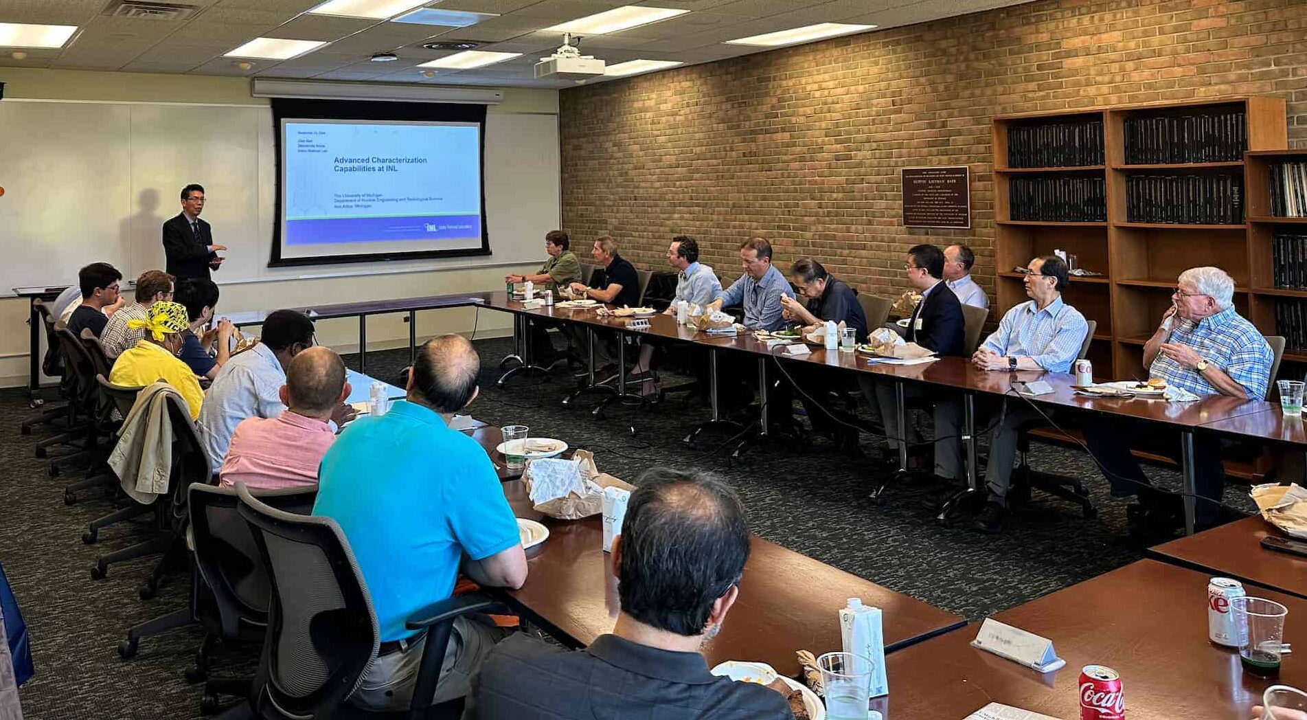 a man gives a presentation to a room full of faculty members